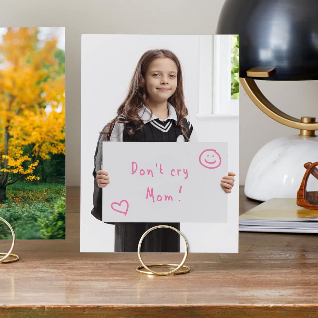 Capture and print a portrait of your child on the first day of school with a funny sign for Mom or Dad.