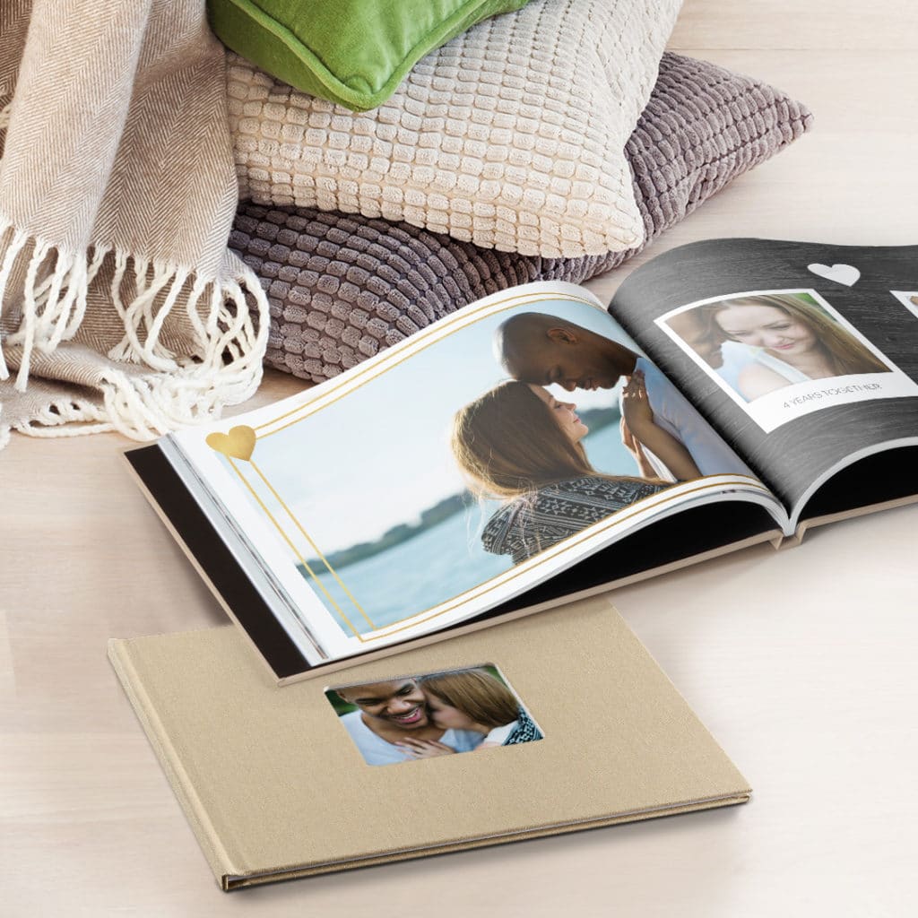 a linen photo book on floor, shown open and closed