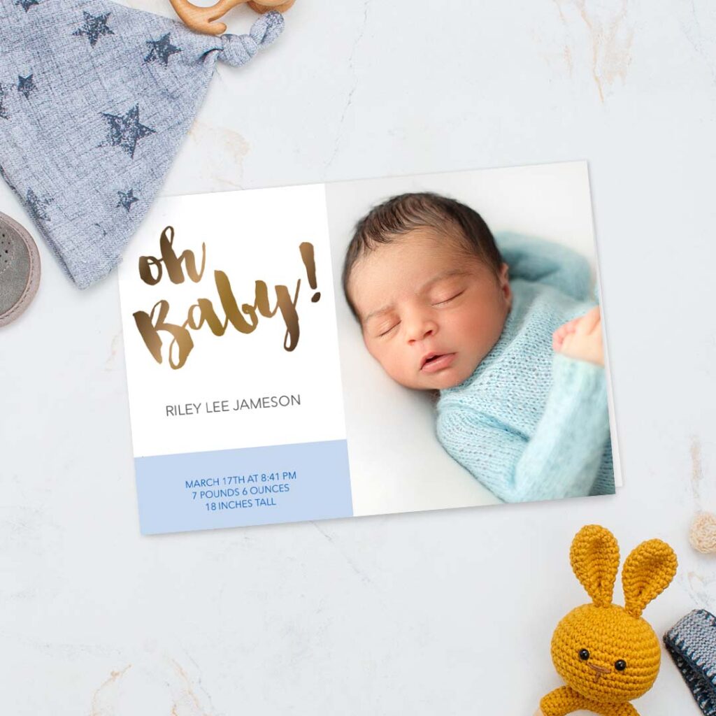 Baby boy announcement card displayed on a blue surface