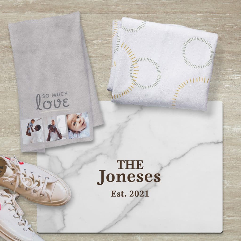 Image of towels and a bathroom floor mat featuring gray and marble designs