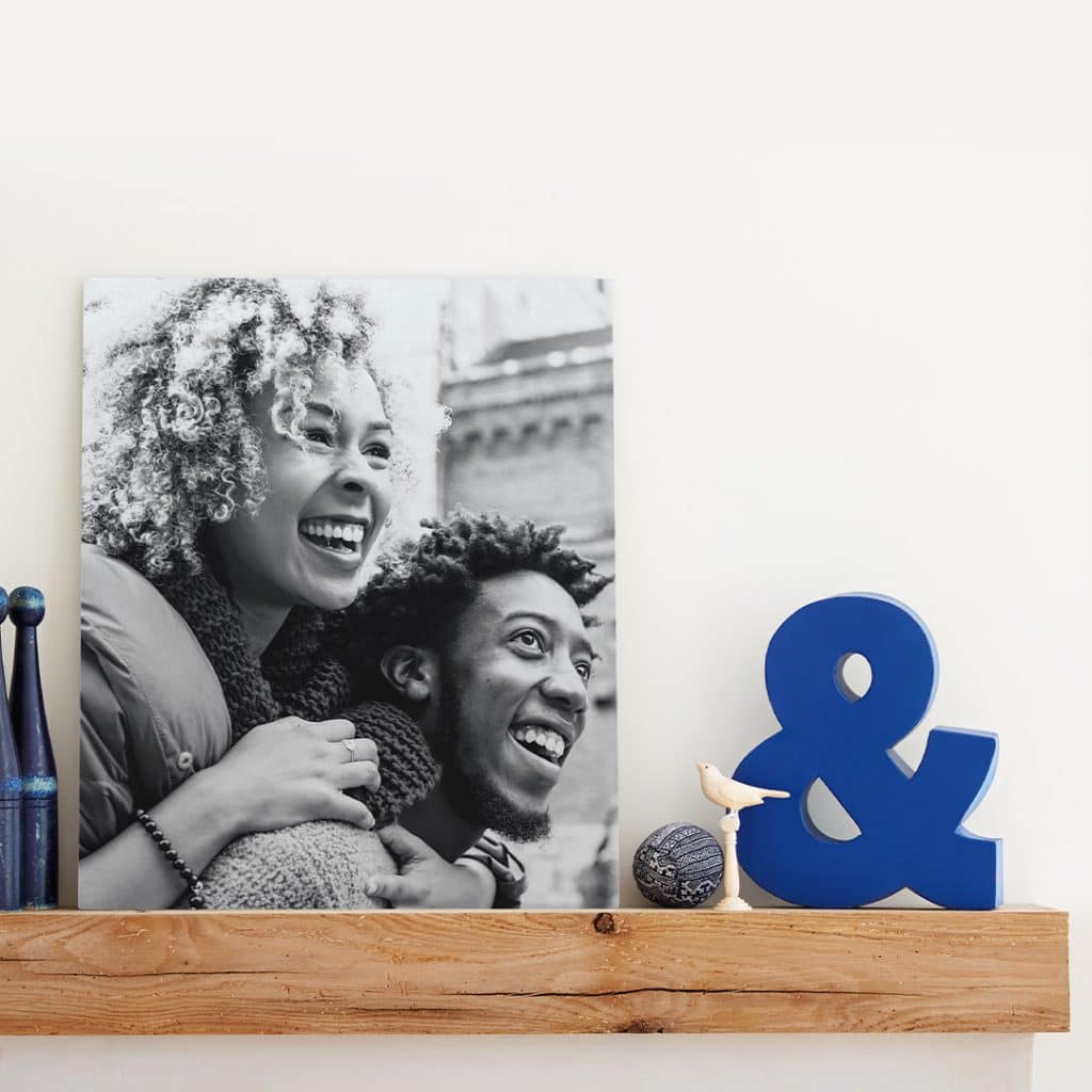 Photo featuring a metal photo print sitting on a shelf next to other décor items