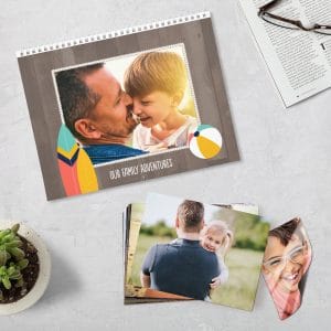 Flat lay image featuring custom calendar, photo prints, and magnet