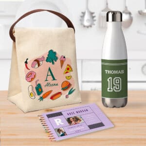 Image of a custom lunch bag, colored pencil set, and water bottle sitting on a kitchen countertop